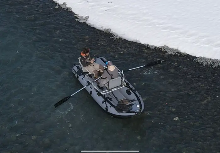 Aerial shot of two anglers rowing a framed raft